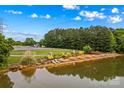 Scenic community lake offers picnic tables, lounge chairs, a dock and natural beauty at 4159 Isle Of Pines Dr, Denver, NC 28037