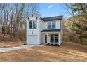 Charming two-story white home featuring a garage and a well-manicured lawn at 4219 Brownwood Nw Ln, Concord, NC 28027