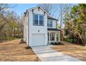 Charming two-story white home featuring a garage, covered front porch and well-manicured landscaping at 4219 Brownwood Nw Ln, Concord, NC 28027