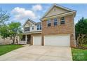 Lovely exterior showcasing a two-story home with a two-car garage and welcoming porch at 4607 Crewe Hall Ln, Waxhaw, NC 28173