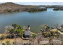Aerial shot of a waterfront property with private dock, surrounded by serene lake and lush greenery at 466 Shoreline Rd, New London, NC 28127