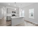 Bright kitchen with white cabinetry, stainless steel appliances, and a large center island at 4724 Lakeview Rd # 26, Charlotte, NC 28216