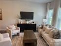 Inviting living room with neutral tones, modern furniture, and lots of natural light at 5103 Orchardview Way # 27, Charlotte, NC 28216