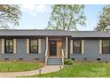 Inviting front entrance with a stylish door, well-maintained steps, and manicured landscaping at 7009 Wrentree Dr, Charlotte, NC 28210