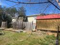 View of the back exterior of a ranch style house with a shed, wooden fence and foliage at 7122 Pyramid Rd, Hickory, NC 28602