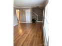 Spacious living area with hardwood floors, staircase, and natural light from large windows at 7307 Meadowland Dr, Charlotte, NC 28215