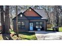 Front view of a cozy home featuring a blue door, seating on the porch, and dark trim at 782 Chalice Sw St, Concord, NC 28027