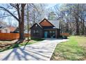 Exterior shot of a home with a light blue door, well-manicured lawn, and long driveway at 782 Chalice Sw St, Concord, NC 28027