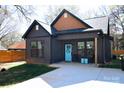A close exterior of a home featuring a front porch with black seating and a front door with letter at 782 Chalice Sw St, Concord, NC 28027