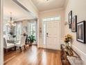 Bright foyer with hardwood floors, complemented by a dining area with large windows at 8812 Heron Glen Dr, Charlotte, NC 28269