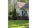 Exterior view of a house with a deck and stairs, surrounded by greenery, offering a relaxing outdoor living space at 113 Duval Ct, Mooresville, NC 28117