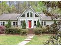 Inviting home with a red front door, large windows, and manicured landscaping, offering great curb appeal at 113 Duval Ct, Mooresville, NC 28117