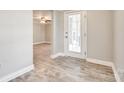 Bright entryway with light wood-look flooring, leading to an open floor plan and a glass-paneled door at 1157 Cedar Grove Ln, Rock Hill, SC 29732