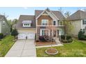Beautiful two-story home with a well-maintained lawn, front garden, and an attached two-car garage at 1224 Screech Owl Rd, Waxhaw, NC 28173