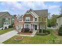 Inviting two-story home boasting lush landscaping, a manicured lawn, and a charming front entrance at 1224 Screech Owl Rd, Waxhaw, NC 28173