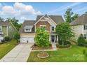 Inviting two-story home with a two-car garage, well-kept lawn, and attractive landscaping at 1224 Screech Owl Rd, Waxhaw, NC 28173