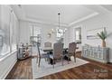 Elegant dining room with modern chandelier, tray ceiling, and large windows for natural light at 1255 Fishing Creek Rd, Clover, SC 29710
