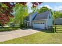 Charming two-story home features a spacious driveway, an attached garage, and beautifully landscaped front yard at 12604 Cardinal Point Rd, Charlotte, NC 28269