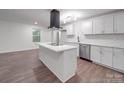 A modern kitchen features an island, stainless steel appliances, and crisp white cabinetry at 129 Wilson St, Chester, SC 29706