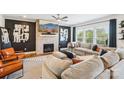 Spacious living room with a brick fireplace, comfortable seating, and plenty of natural light at 13102 Petrel Pl, Charlotte, NC 28278