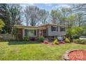 Split-level home with a brick and siding exterior, front lawn and small garden at 1421 Sherwood Dr, Kannapolis, NC 28081
