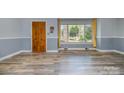 Living room featuring neutral wall colors, updated flooring, and a large window at 1421 Sherwood Dr, Kannapolis, NC 28081