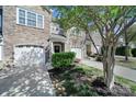 A row of townhomes showcasing stone accents, garages, and well-maintained landscaping at 14256 Drake Watch Ln, Charlotte, NC 28262