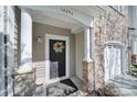 Charming front door with a decorative wreath and stone accents at 14256 Drake Watch Ln, Charlotte, NC 28262