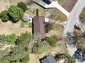 Aerial view of a house featuring a brown roof, mature trees, and a well-maintained yard in a residential neighborhood at 206 Cliffside Dr, Kannapolis, NC 28081