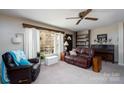 Warm living room featuring a cozy seating area, built-in shelving, piano, and a bright window that invites natural light at 206 Cliffside Dr, Kannapolis, NC 28081
