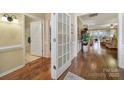 Hallway with hardwood floors that lead to the bathroom and living room at 2158 Hartwell Ln, Fort Mill, SC 29707