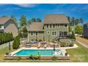 Aerial view showcasing a private backyard oasis with a pool, patio, and lush landscaping at 2220 Gallberry Ln, Waxhaw, NC 28173