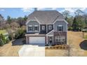 Beautiful two-story home with stone and siding exterior, a spacious driveway, and landscaped front yard at 2248 Killian Creek Dr, Denver, NC 28037