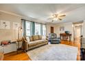 Bright living room with hardwood floors, sofa, recliner, and a ceiling fan at 236 Greendale Dr, Mount Holly, NC 28120