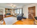 Cozy living room features a brick fireplace, hardwood floors, and comfortable seating at 236 Greendale Dr, Mount Holly, NC 28120