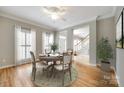 Bright dining room with wood floors, round table, and large windows at 2515 Barrington Ct, Rock Hill, SC 29732