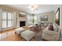 Cozy living room featuring a fireplace, large windows, and comfortable seating arrangements at 2515 Barrington Ct, Rock Hill, SC 29732