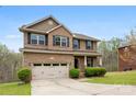 Beautiful two-story home with a manicured lawn, brick facade, and inviting front porch at 2548 Flintshire Ln, Gastonia, NC 28056
