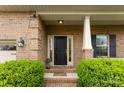 Elegant front door entrance with decorative sidelights and manicured landscaping at 2548 Flintshire Ln, Gastonia, NC 28056