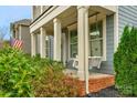 Inviting front porch with swing and beautiful landscaping at 3013 Kensley Dr, Waxhaw, NC 28173
