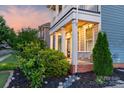 Inviting front porch features a swing and classic columns, offering a relaxing outdoor space at 3013 Kensley Dr, Waxhaw, NC 28173
