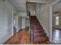 Inviting hallway featuring a carpeted staircase and classic wood trim at 35 E Catawba St, Belmont, NC 28012