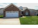 Charming single-story brick home featuring an attached two-car garage and well-maintained lawn at 403 Garner Dr, Salisbury, NC 28146