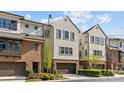 Beautiful townhome featuring brick and stucco exterior, well-maintained landscaping, and an attached two-car garage at 4038 City Homes Pl, Charlotte, NC 28209