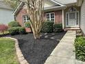 Inviting brick home with a manicured front yard, walkway, and garden beds filled with black mulch at 4608 Mabry Pkwy, Rock Hill, SC 29732