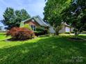 Exterior shot of home, showcasing the lawn, colorful landscaping, and attached two-car garage at 4608 Mabry Pkwy, Rock Hill, SC 29732