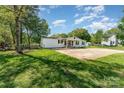 Home featuring a large concrete pad and well-manicured lawn, perfect for outdoor activities at 4767 Stratford Ln, Denver, NC 28037