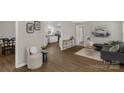 Open-concept living room featuring modern decor, hardwood floors, and seamless flow to the kitchen at 6057 Highway 97 Hwy, Hickory Grove, SC 29717