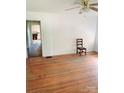 Living room with hardwood floors, ceiling fan and view into the kitchen of the property at 6309 New Town Rd, Waxhaw, NC 28173
