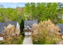 Aerial view of a suburban home nestled among lush green trees and well-maintained landscaping at 8619 Delamere Ln, Charlotte, NC 28269